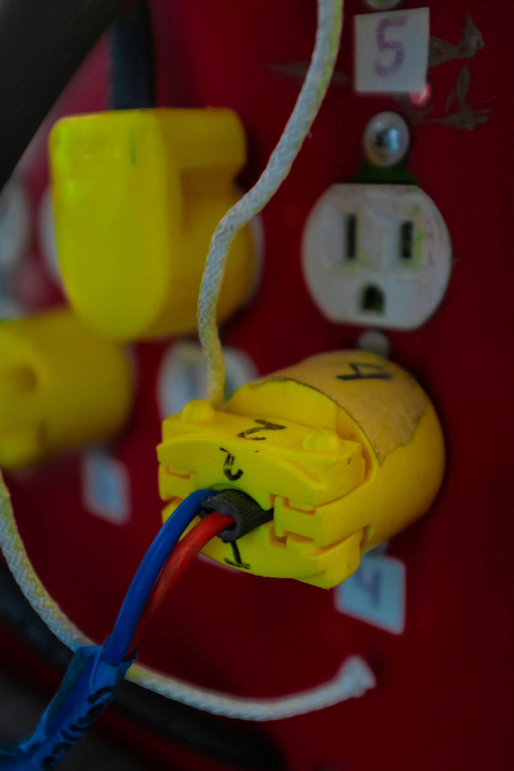 Red wall receptacle with a yellow plug connected