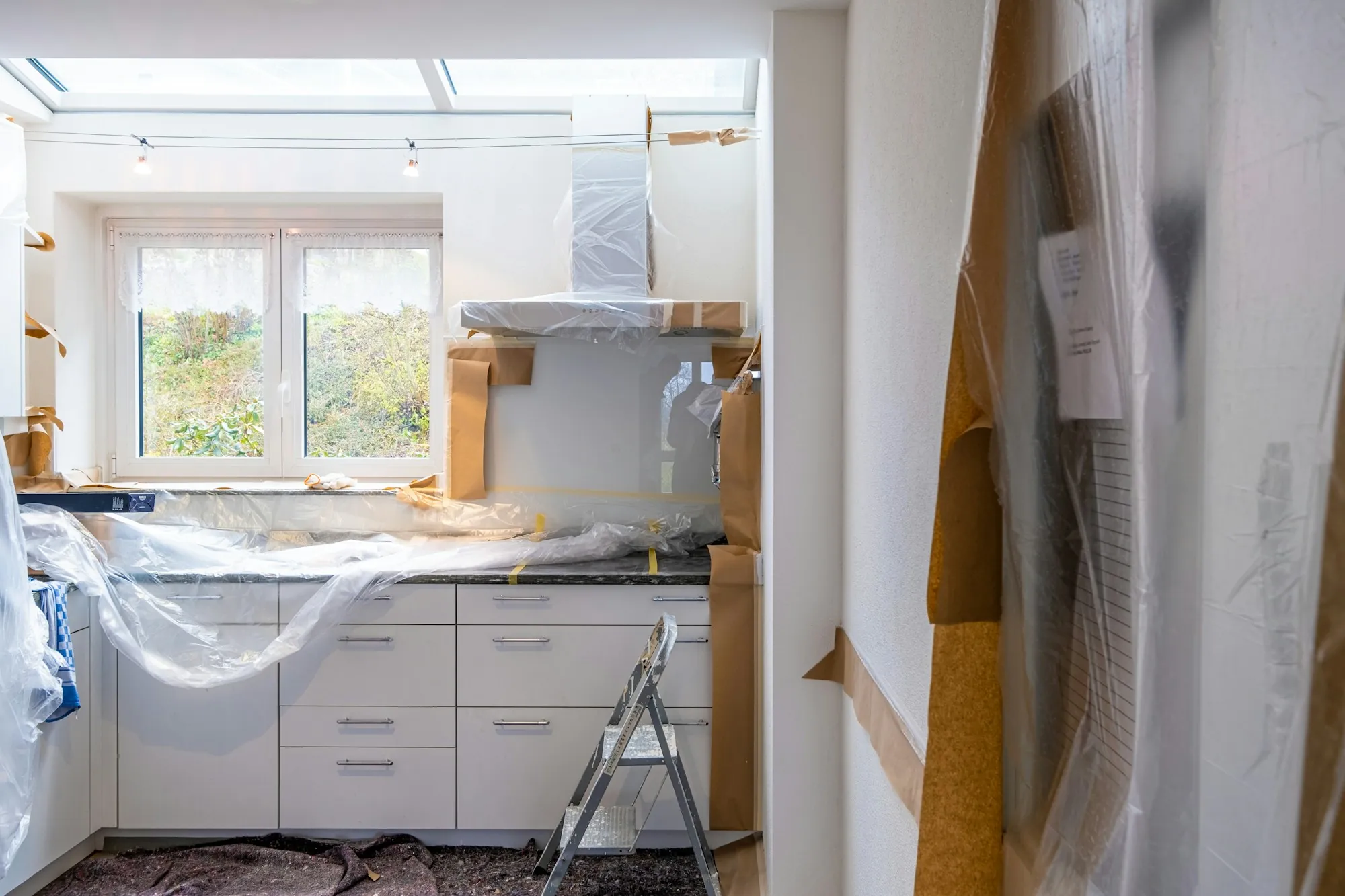 Kitchen being renovated with cabinets in and walls open
